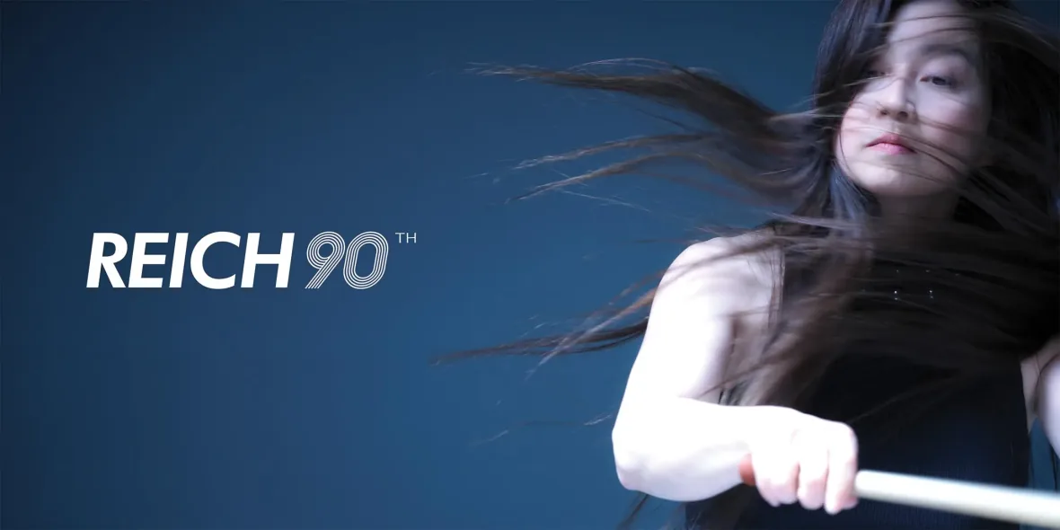 REICH90 wordmark with a performer holding a mallet