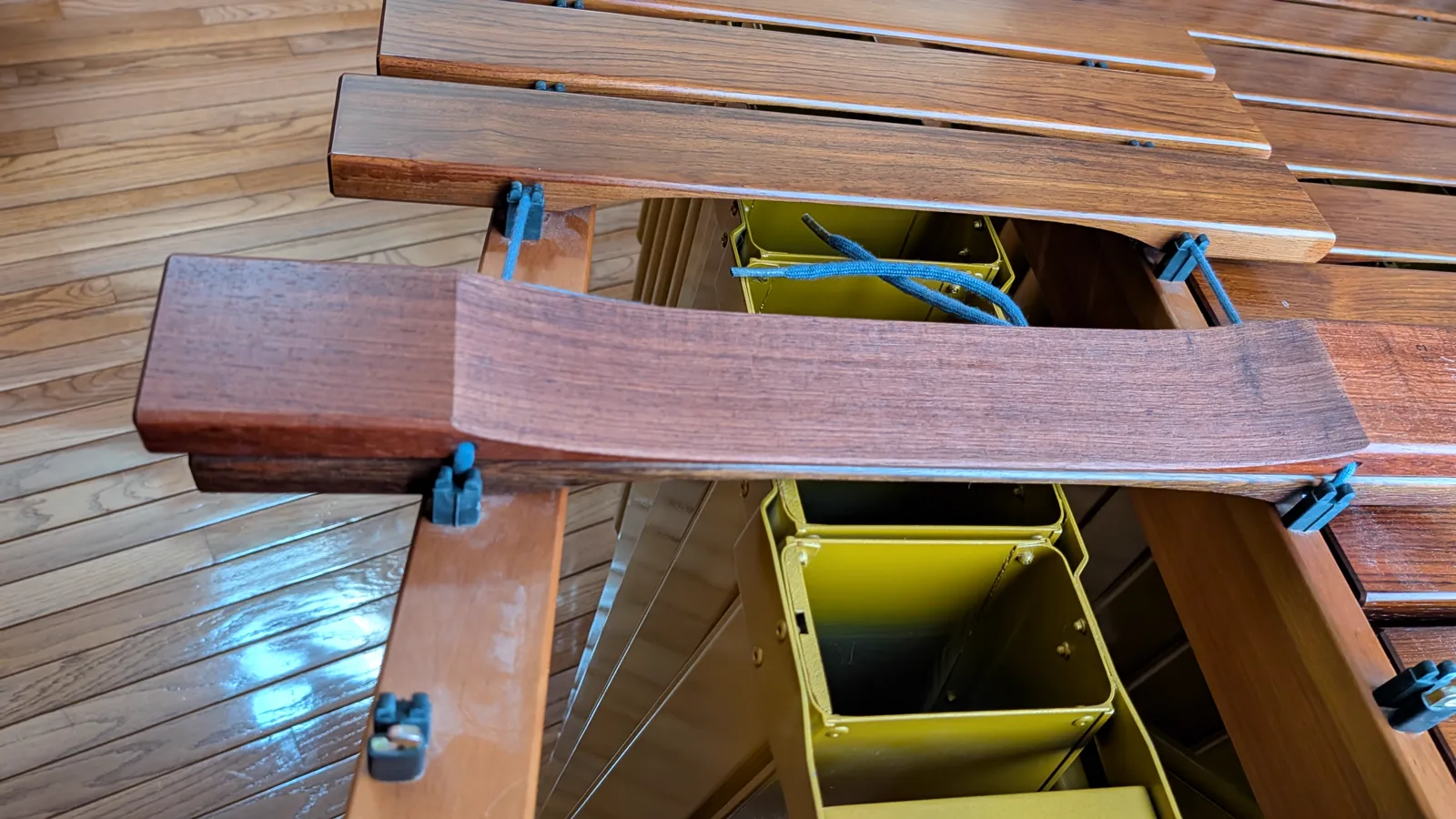 Underside of a low marimba bar, showing the curved area removed during tuning